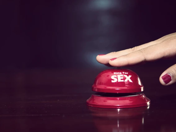 A hand presses a button that says ring for sex