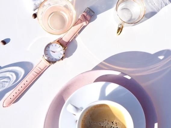 A table with coffee and a watch